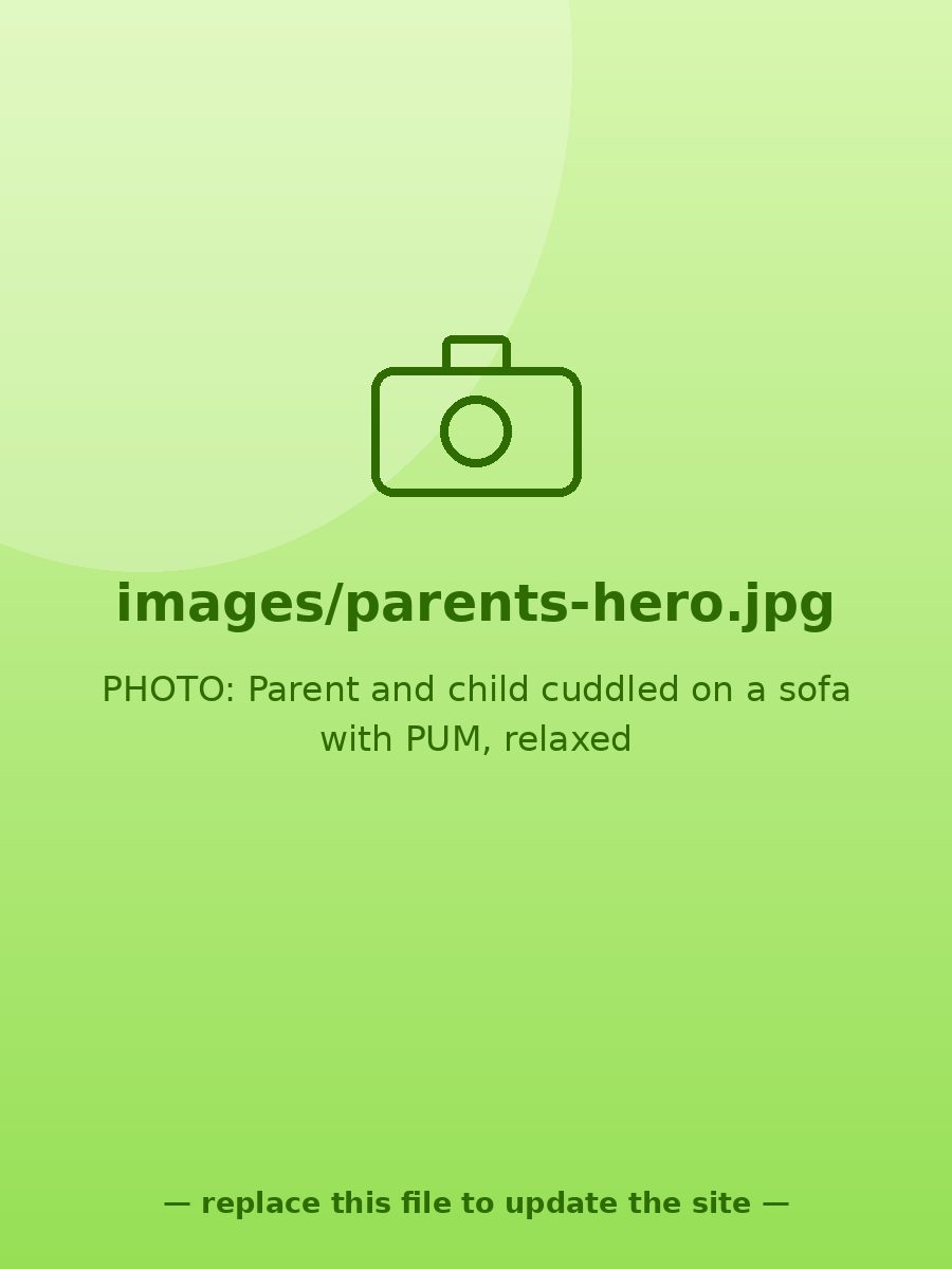 Parent and child cuddled on a sofa, child holding PUM, both relaxed and happy