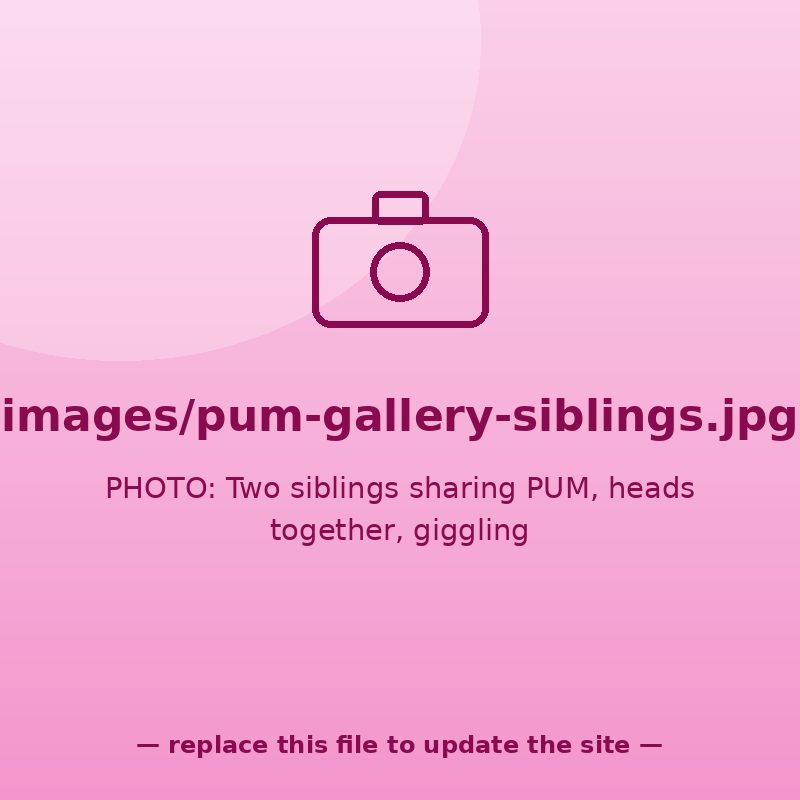 Two siblings sharing PUM, heads together, giggling